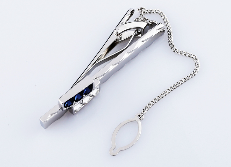 Tie clip inlaid with jewelry